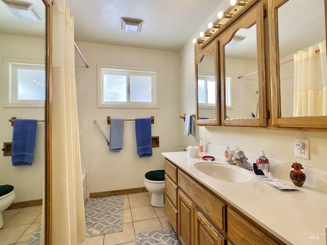 full bath with visible vents, vanity, toilet, and a healthy amount of sunlight