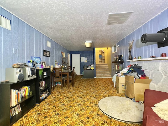 interior space with visible vents, stairway, and a textured ceiling