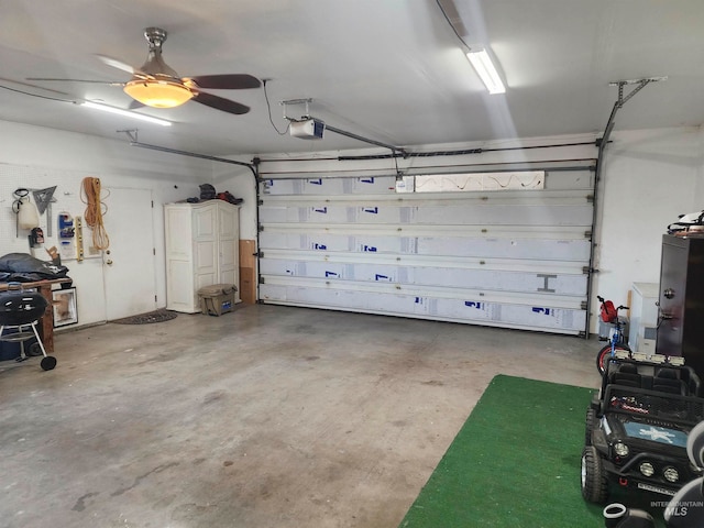 garage featuring ceiling fan and a garage door opener