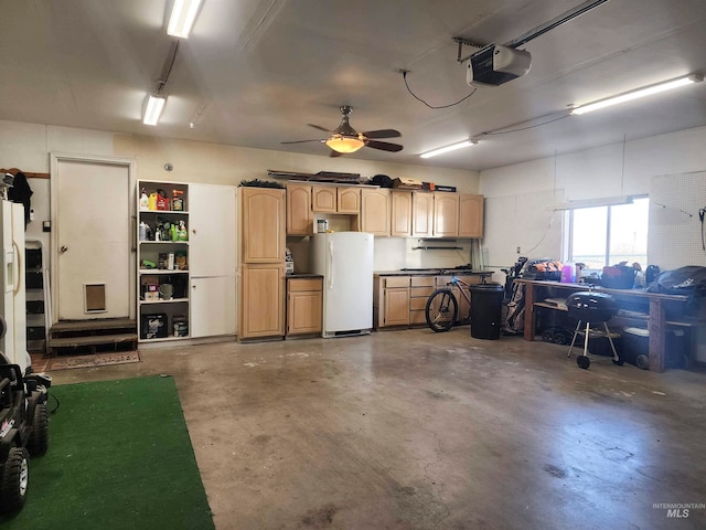 garage with ceiling fan, white refrigerator, and a garage door opener