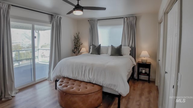 bedroom with access to outside, ceiling fan, and hardwood / wood-style floors