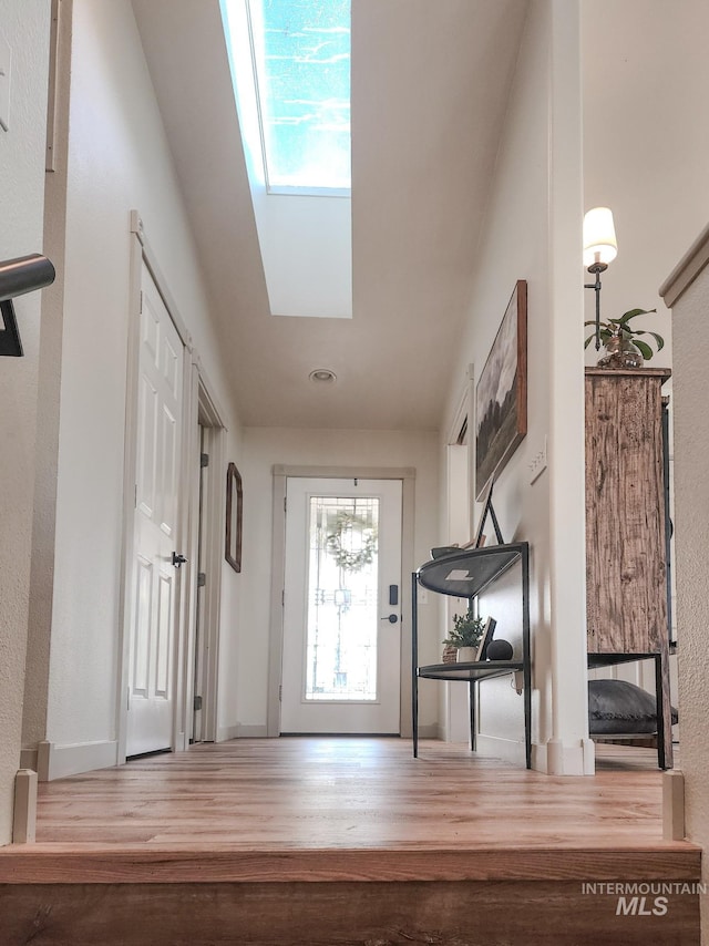 entrance foyer with a skylight and hardwood / wood-style flooring