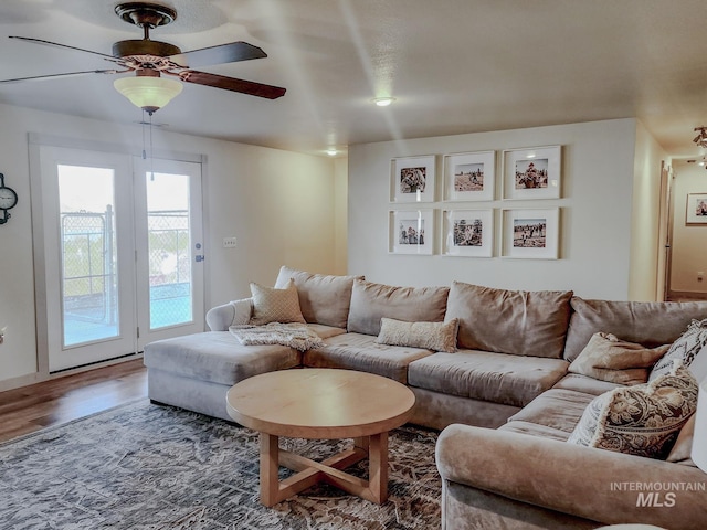 living room featuring hardwood / wood-style floors and ceiling fan