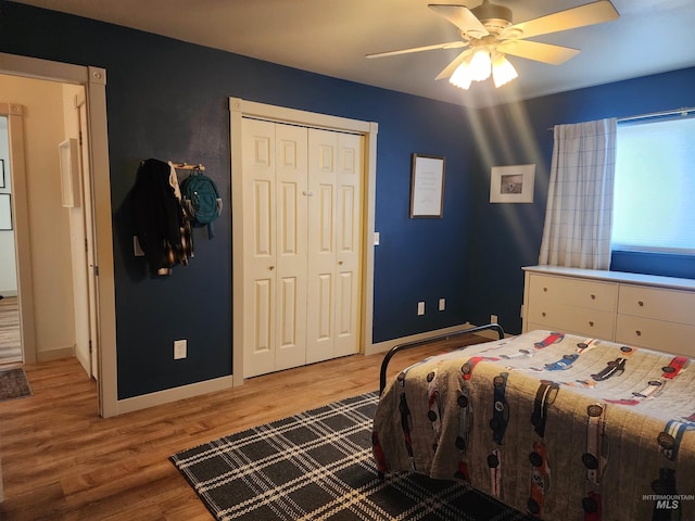 bedroom with light wood-type flooring, a closet, and ceiling fan