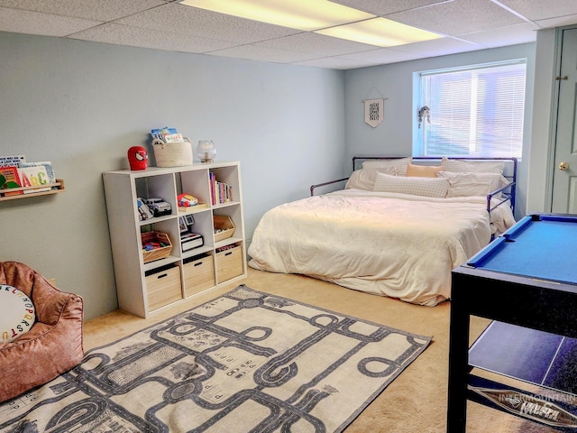 bedroom featuring carpet flooring, a paneled ceiling, and pool table