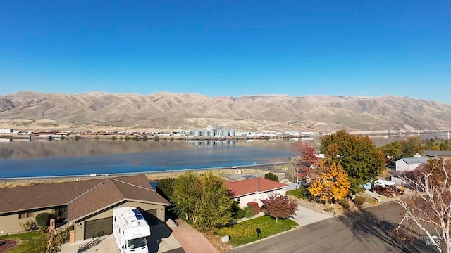 birds eye view of property with a water and mountain view