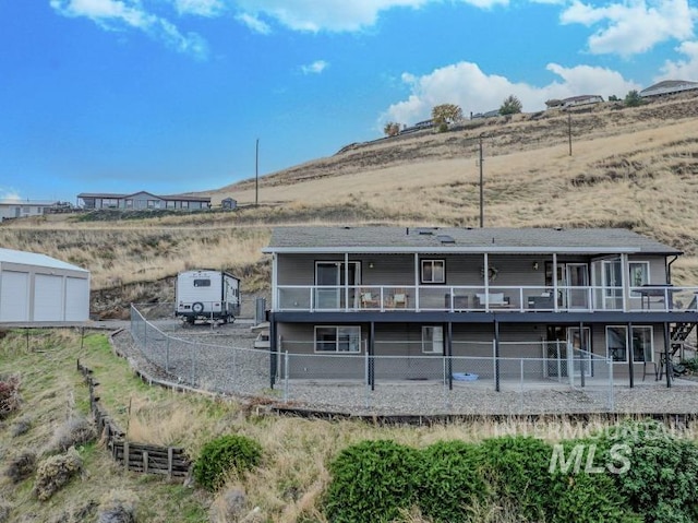 rear view of property featuring a wooden deck