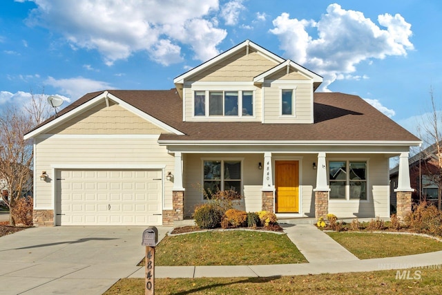 craftsman inspired home with a front yard, a porch, and a garage