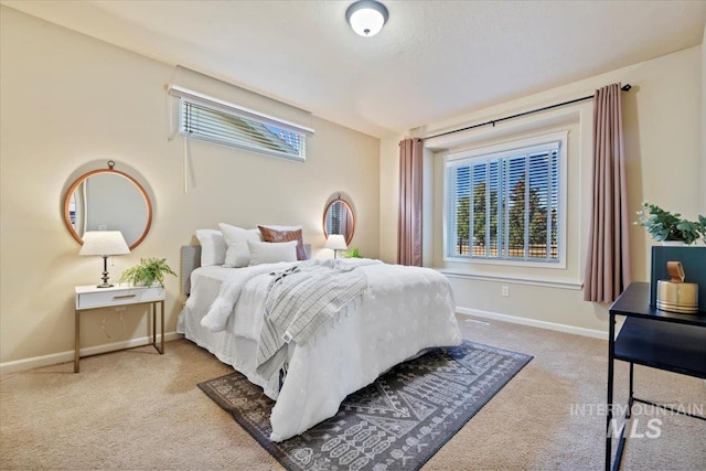 bedroom with carpet flooring and baseboards