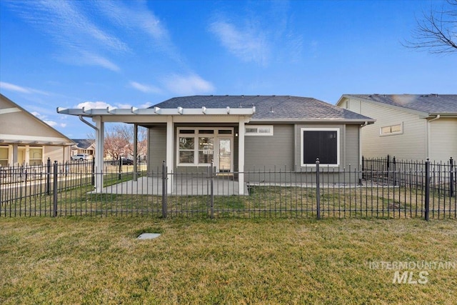 back of house with a yard and a fenced front yard