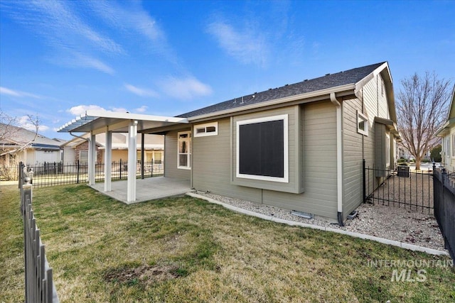 back of house featuring a yard, a patio, and fence