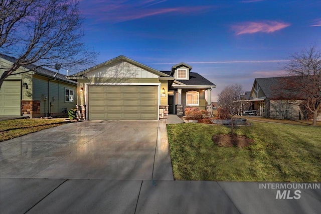 view of front of home with concrete driveway, a garage, stone siding, and a front lawn