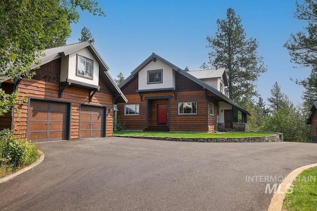 log cabin featuring a garage