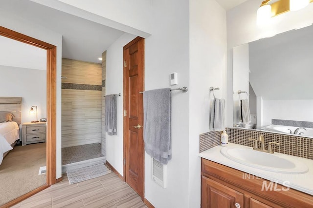 bathroom featuring vanity and a tile shower