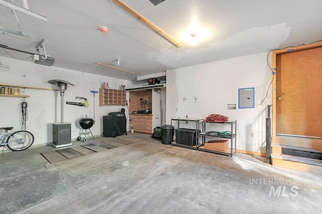 garage with a garage door opener and electric panel