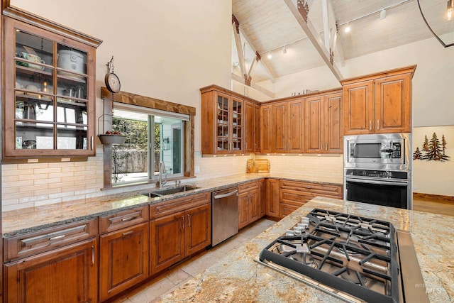 84 Jughandle Dr, Mccall, ID 83638 - kitchen with appliances with stainless steel finishes, a sink, track lighting, wooden ceiling, and light stone counters