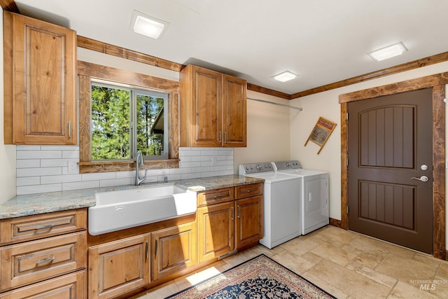 84 Jughandle Dr, Mccall, ID 83638 - washroom with washing machine and dryer, cabinet space, stone tile floors, baseboards, and ornamental molding