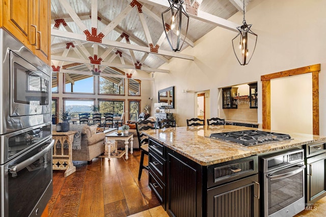 84 Jughandle Dr, Mccall, ID 83638 - kitchen with stainless steel appliances, high vaulted ceiling, wooden ceiling, light stone counters, and hardwood / wood-style floors