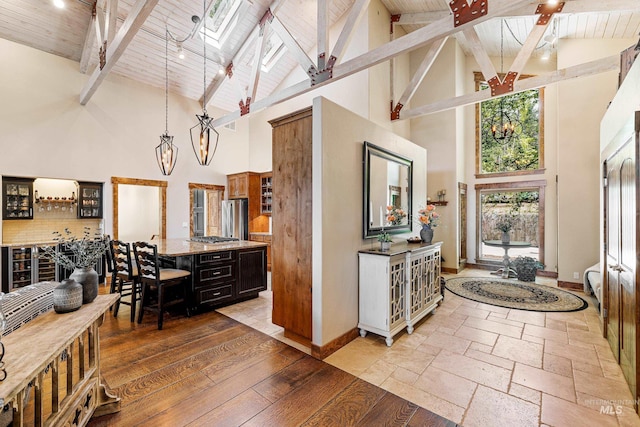 84 Jughandle Dr, Mccall, ID 83638 - kitchen with high vaulted ceiling, freestanding refrigerator, wooden ceiling, glass insert cabinets, and a center island