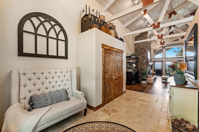 84 Jughandle Dr, Mccall, ID 83638 - sitting room featuring high vaulted ceiling, beamed ceiling, wood ceiling, baseboards, and stone tile floors