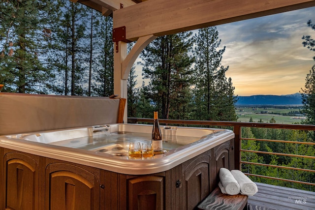 84 Jughandle Dr, Mccall, ID 83638 - deck at dusk with a hot tub and a mountain view
