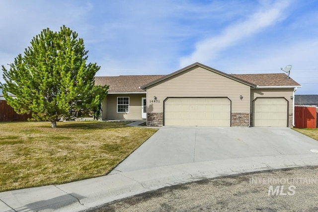 ranch-style house featuring driveway, fence, an attached garage, a shingled roof, and a front yard