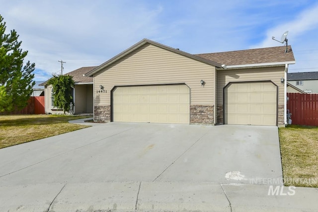 ranch-style house with an attached garage, driveway, a front yard, and fence