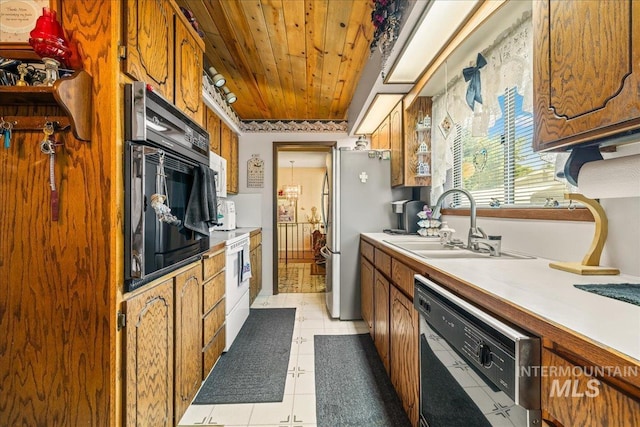 2503 Lyle Ct, Nampa, ID 83651 - kitchen featuring dishwasher, freestanding refrigerator, wooden ceiling, light countertops, and brown cabinetry