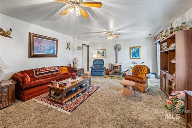 2503 Lyle Ct, Nampa, ID 83651 - living room with carpet flooring, a wood stove, ceiling fan, and a textured ceiling