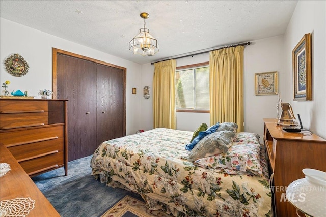 2503 Lyle Ct, Nampa, ID 83651 - bedroom with a closet, carpet flooring, a chandelier, and a textured ceiling