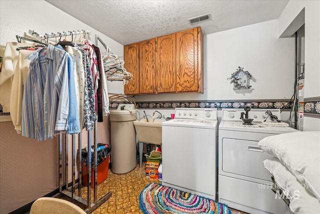 2503 Lyle Ct, Nampa, ID 83651 - washroom featuring washer and dryer, cabinet space, and a textured ceiling