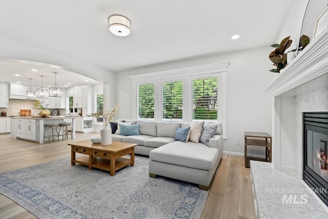 5446 E Branchwood Ct, Boise, ID 83716 - living area with recessed lighting, a fireplace, light wood-style flooring, and a chandelier