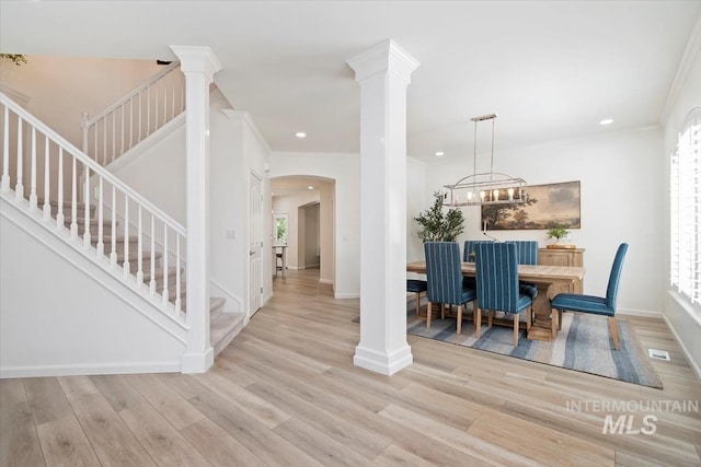 5446 E Branchwood Ct, Boise, ID 83716 - dining area featuring stairway, wood finished floors, arched walkways, recessed lighting, and crown molding