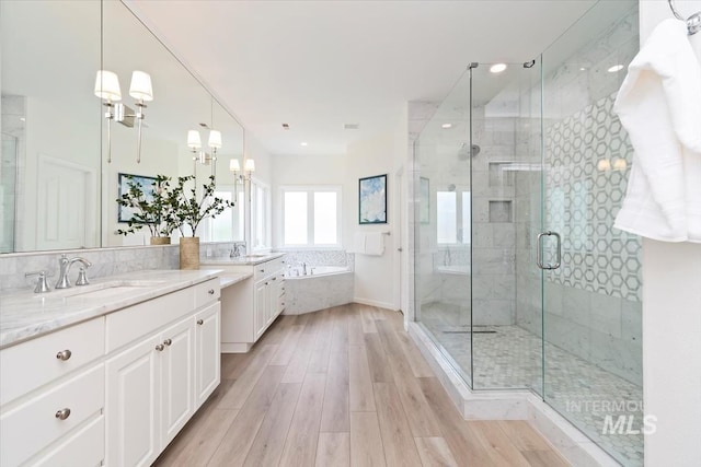 5446 E Branchwood Ct, Boise, ID 83716 - bathroom featuring vanity, a bath, a shower stall, a chandelier, and recessed lighting