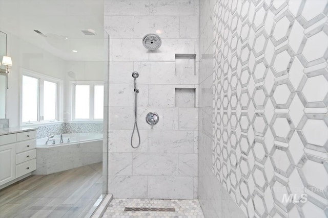 5446 E Branchwood Ct, Boise, ID 83716 - bathroom with a garden tub, a walk in shower, and vanity