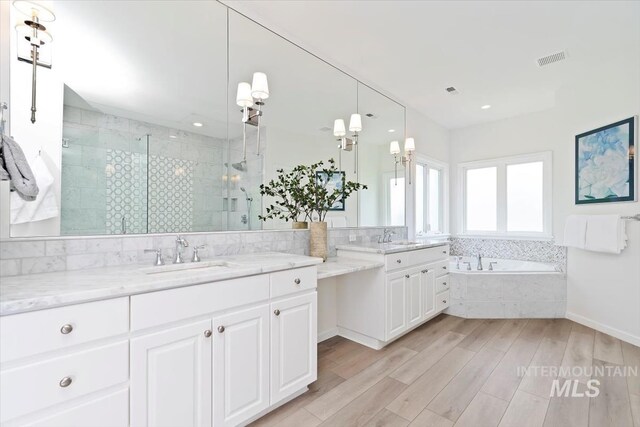 5446 E Branchwood Ct, Boise, ID 83716 - full bathroom with a stall shower, vanity, a bath, wood finished floors, and recessed lighting