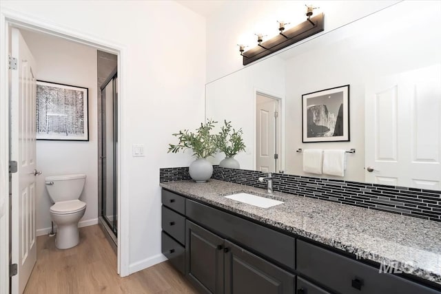 5446 E Branchwood Ct, Boise, ID 83716 - full bath featuring vanity, wood finished floors, a stall shower, and decorative backsplash
