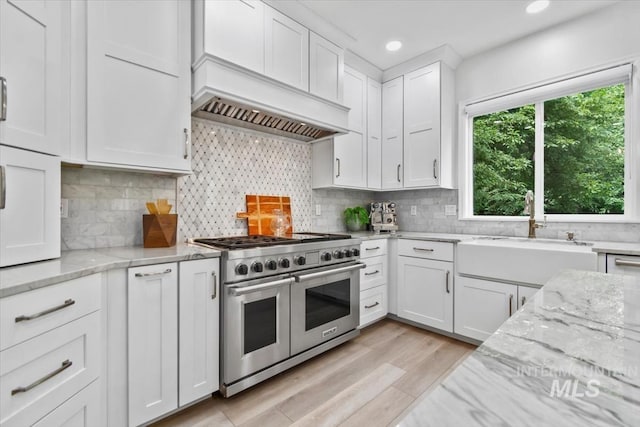 5446 E Branchwood Ct, Boise, ID 83716 - kitchen with double oven range, white cabinetry, recessed lighting, light wood-style floors, and tasteful backsplash