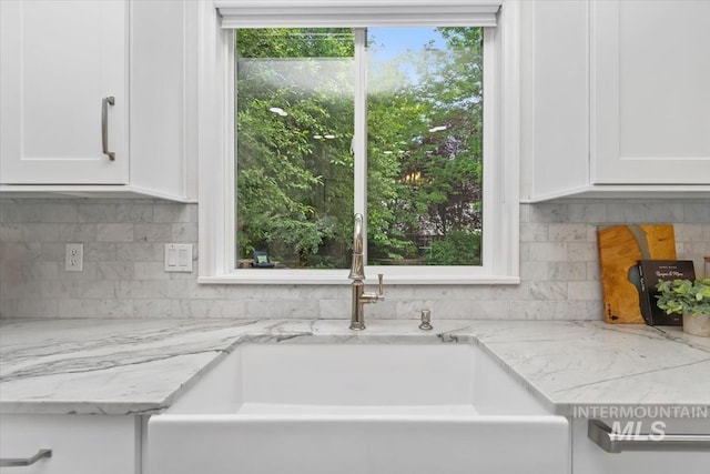 5446 E Branchwood Ct, Boise, ID 83716 - kitchen with white cabinetry, backsplash, and light stone countertops