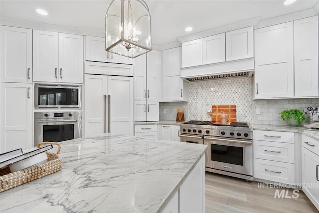5446 E Branchwood Ct, Boise, ID 83716 - kitchen with built in appliances, a chandelier, white cabinets, recessed lighting, and light wood-style flooring