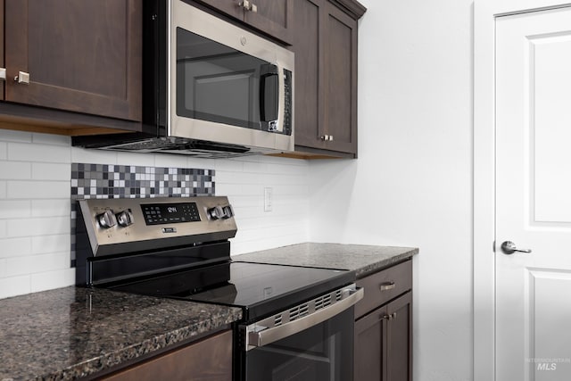 2928 W Los Flores Dr, Meridian, ID 83646 - kitchen with stainless steel appliances, dark brown cabinets, tasteful backsplash, and dark stone counters