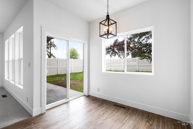 2928 W Los Flores Dr, Meridian, ID 83646 - unfurnished dining area featuring a chandelier, baseboards, and wood finished floors