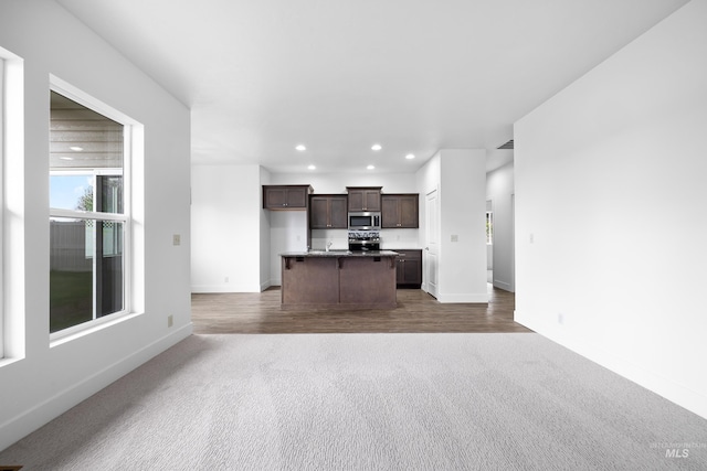 2928 W Los Flores Dr, Meridian, ID 83646 - unfurnished living room featuring carpet flooring, recessed lighting, baseboards, and wood finished floors