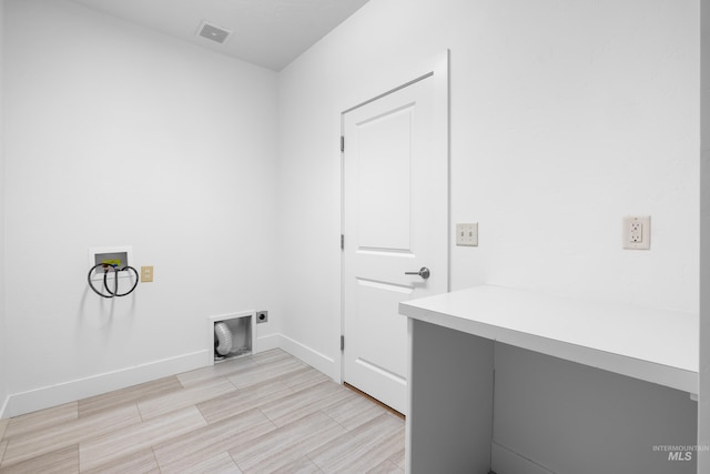 2928 W Los Flores Dr, Meridian, ID 83646 - clothes washing area with hookup for a washing machine, hookup for an electric dryer, baseboards, and light wood-style floors
