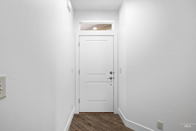 2928 W Los Flores Dr, Meridian, ID 83646 - doorway with dark wood-type flooring and baseboards