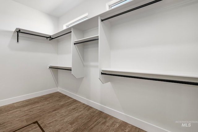 spacious closet with wood finished floors