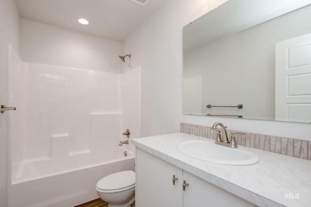 bathroom with shower / bathing tub combination, toilet, vanity, and recessed lighting