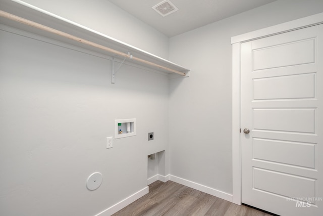 clothes washing area with hookup for an electric dryer, visible vents, washer hookup, wood finished floors, and laundry area