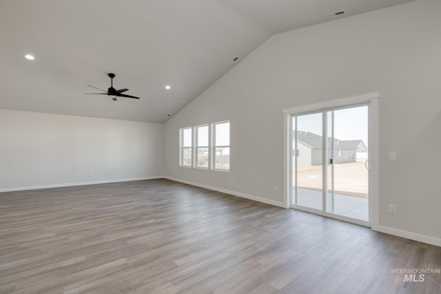 unfurnished living room with wood finished floors, high vaulted ceiling, ceiling fan, and a healthy amount of sunlight