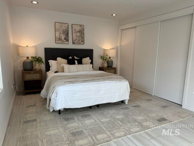 bedroom featuring hardwood / wood-style flooring and a closet